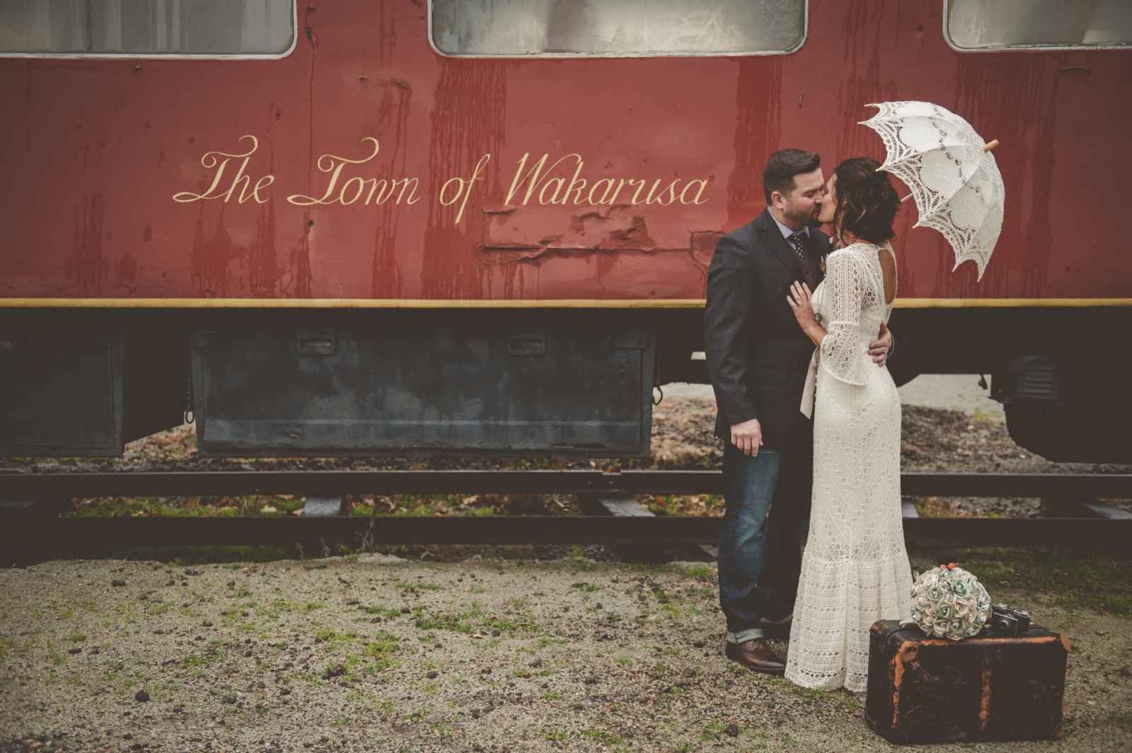couple in front of train