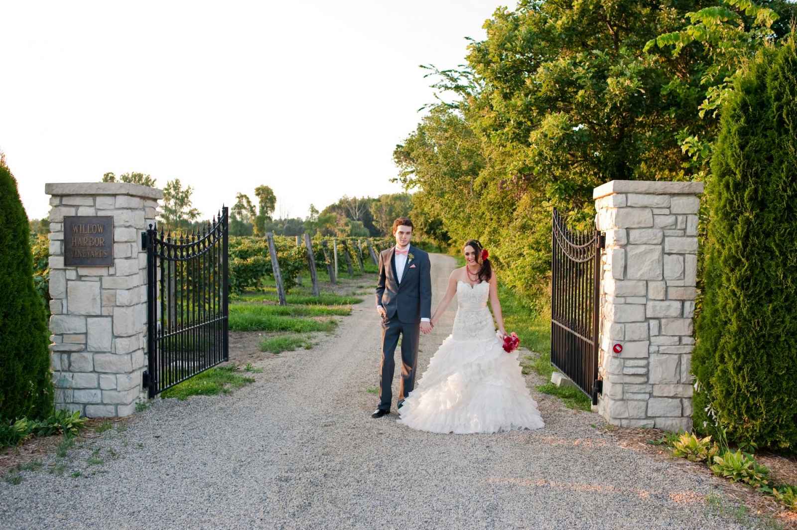bride and groom at gate entrance