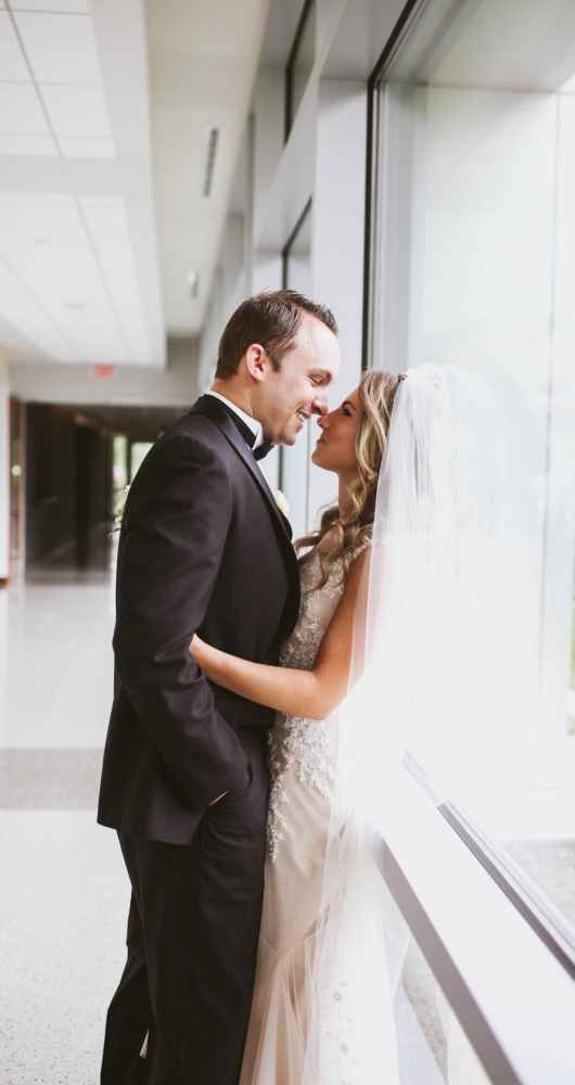 bride and groom kissing at the forum