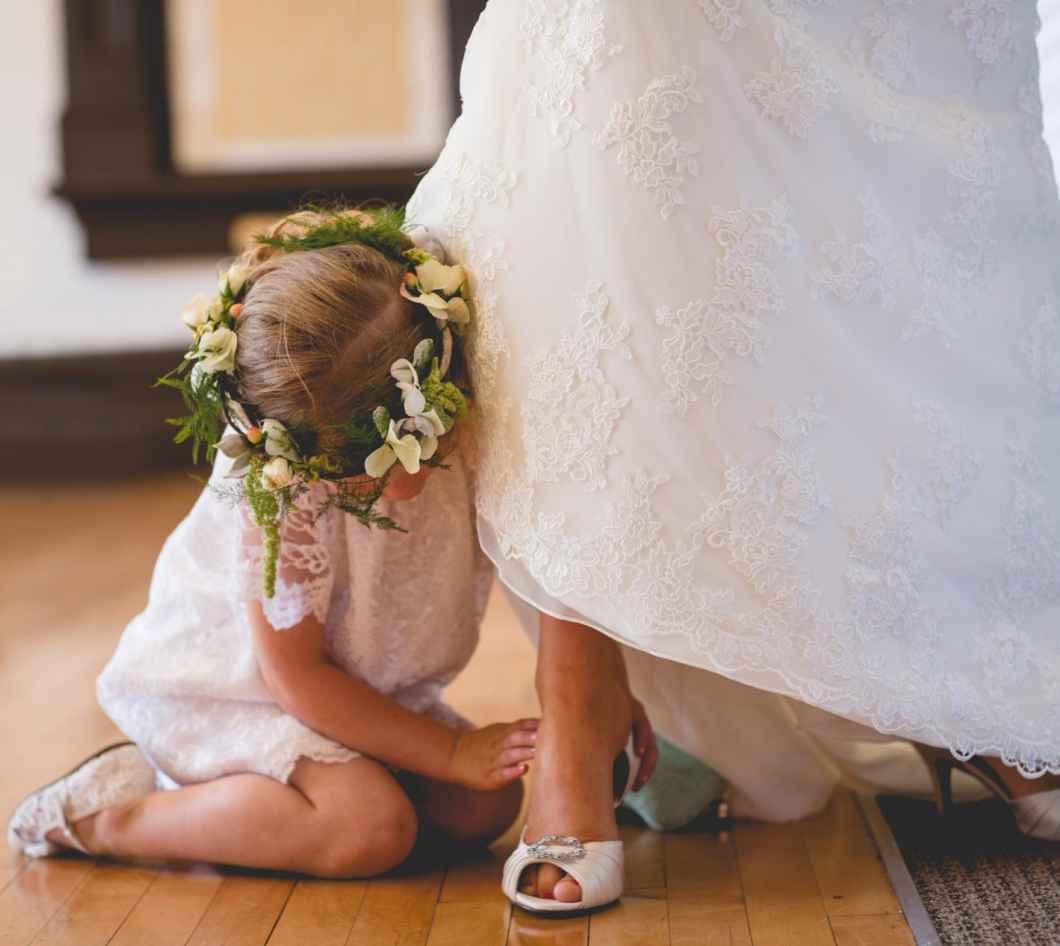 flower girl helping bride