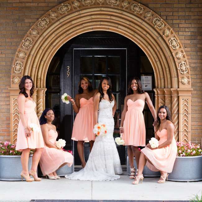 Bridesmaids in Peach Dresses Standing Around Bride