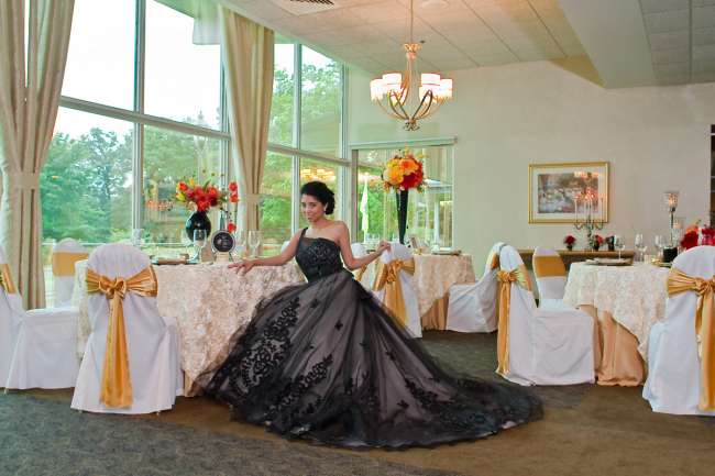 Bride Sitting at Reception in Black Gown