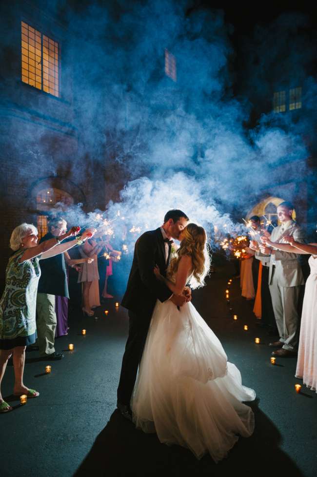 Kiss Surrounded by Guests & Sparklers
