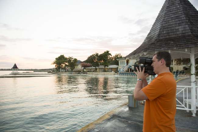 Videographer capturing waterfront scenery