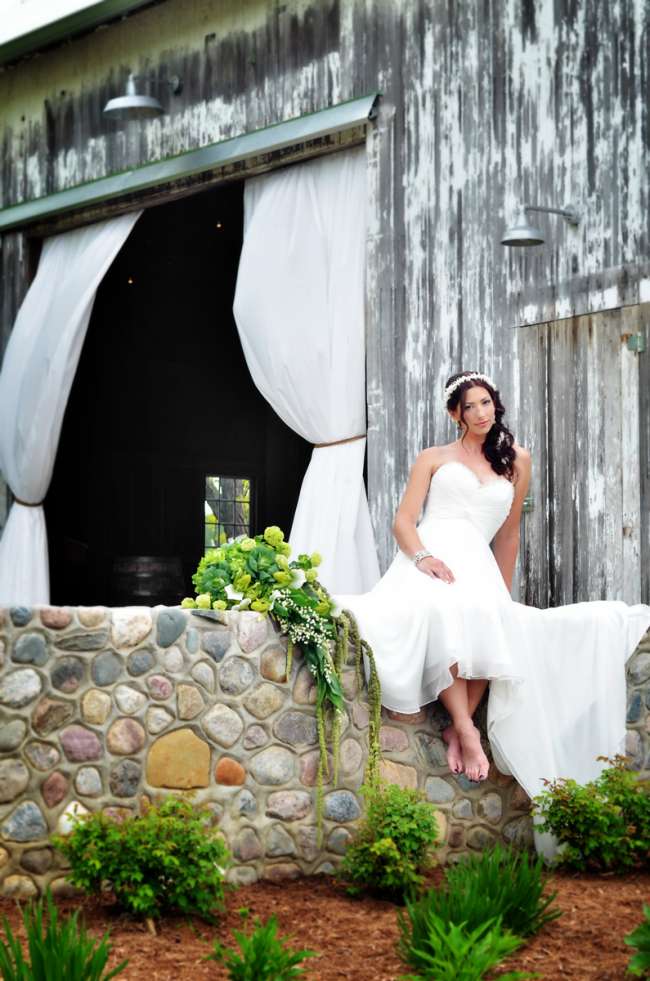 Bride Sitting Outside Barn