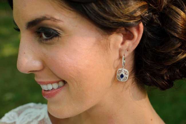 Up close shot of bride with sapphire and diamond earrings