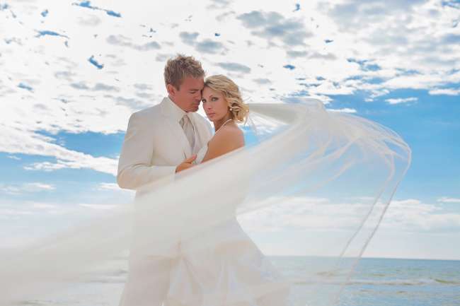 Dramatic Shot of Bride & Groom With Blue Sky