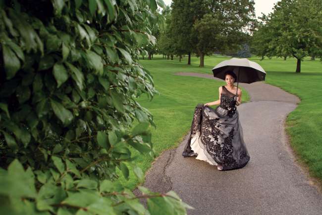 Bride in Black Gown Carries an Umbrella Through Elcona Country Club