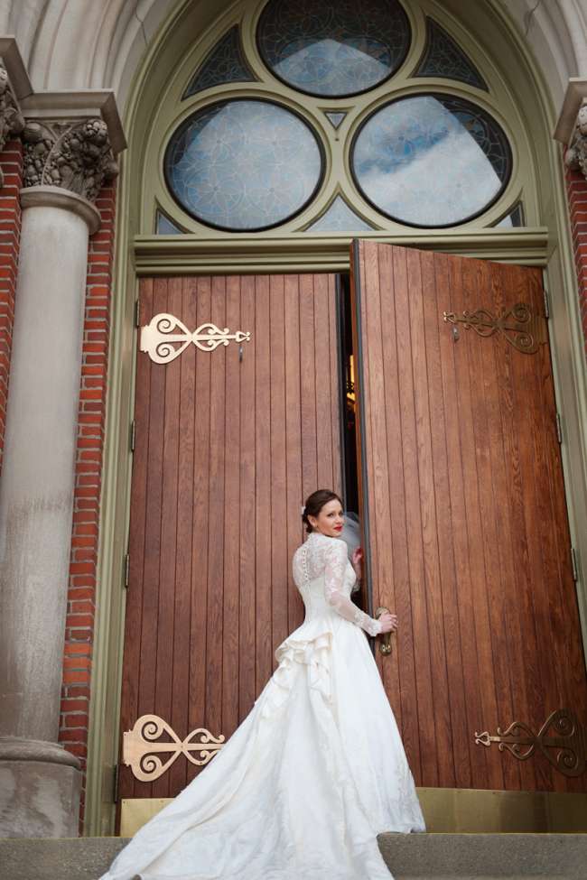 Bride in Long Sleeve, Lace Gown Opening Church Doors