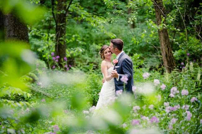 Groom Kisses Bride in the Woods