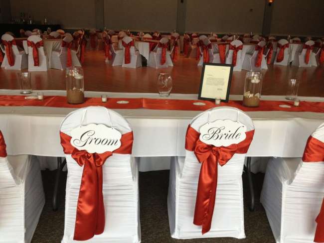 Head Table With Bride & Groom Signs on Chairs