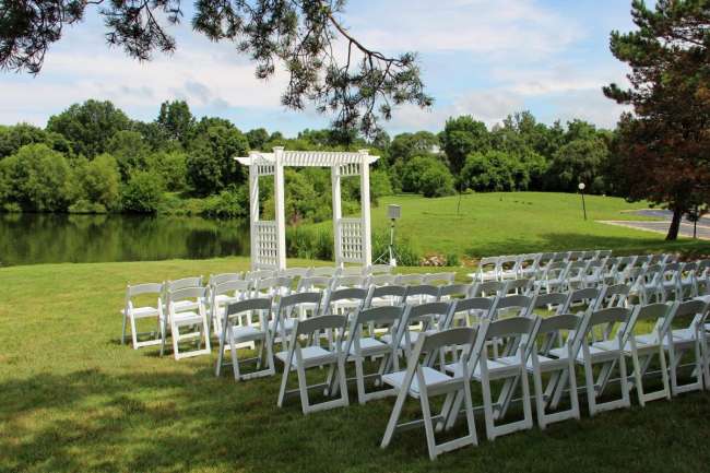 Outdoor ceremony overlooking inland lake and woods