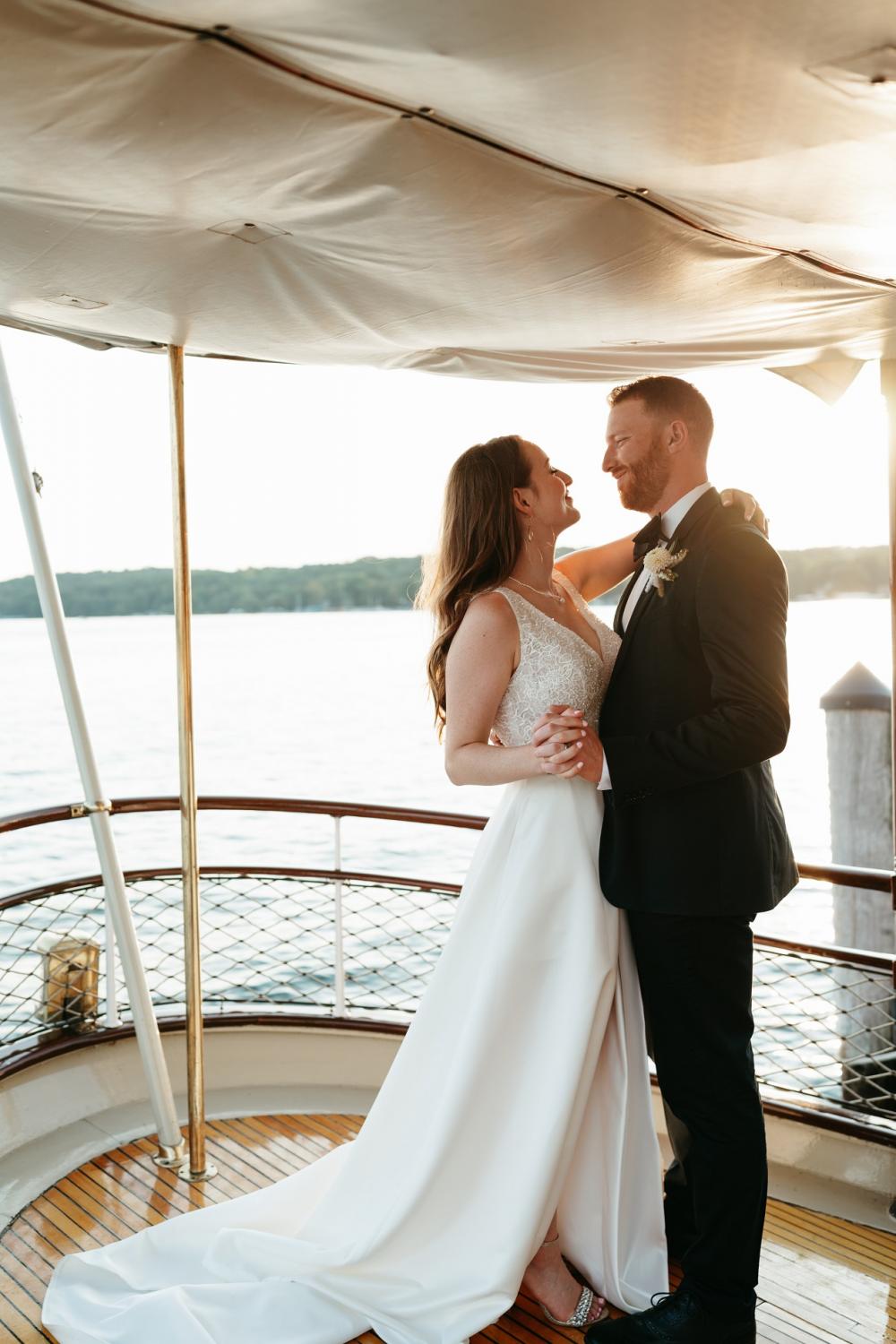Fashionable bride with large straw hat lace cover up on yacht - Greg Finck  Photography
