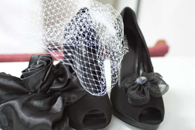 Black Heels With Tulle Bow Next to Birdcage Veil