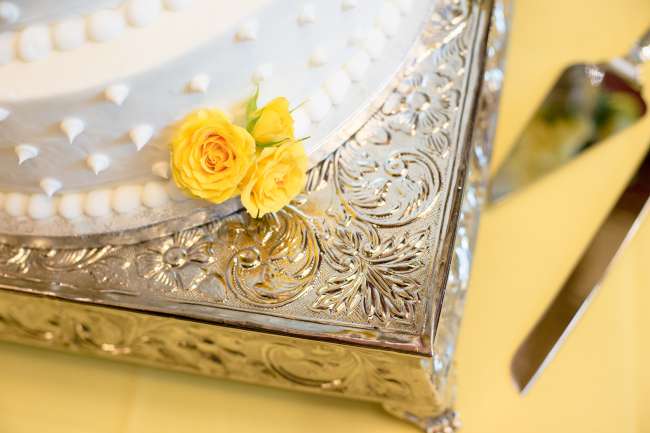 Detail of White Wedding Cake with Yellow Flowers