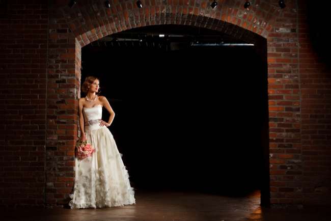Bride Holding a Bouquet in Front of a Brick Wall