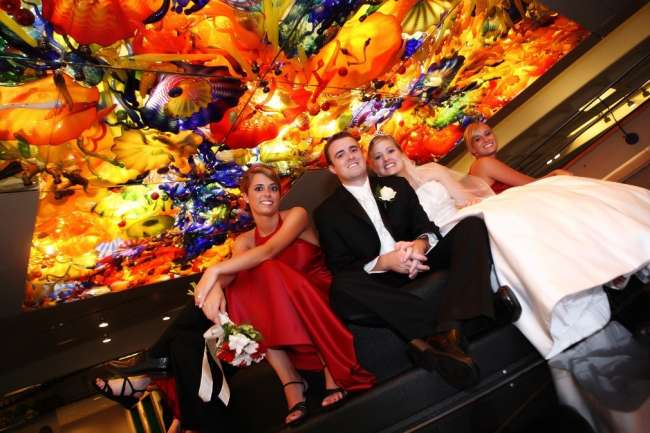 Wedding party poses beneath kaleidoscope ceiling