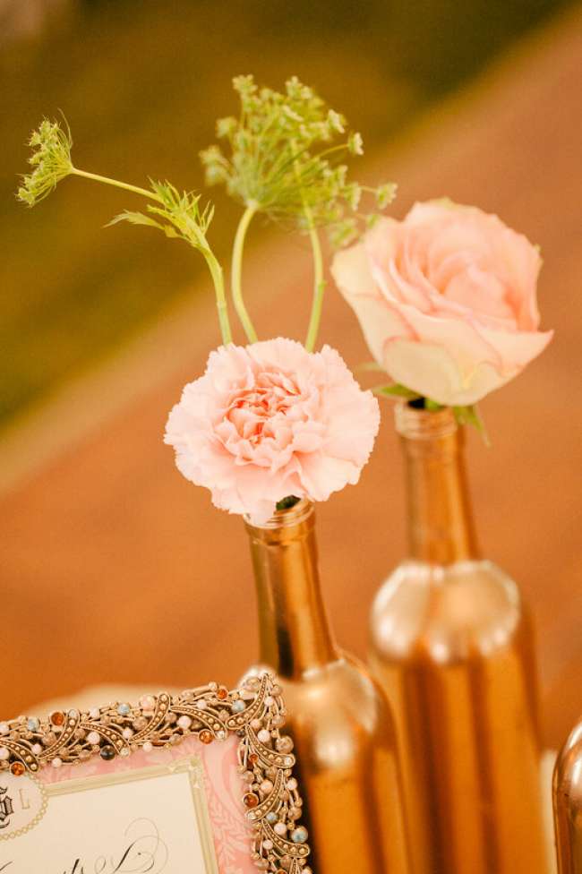 Gold painted wine bottles used as centerpieces