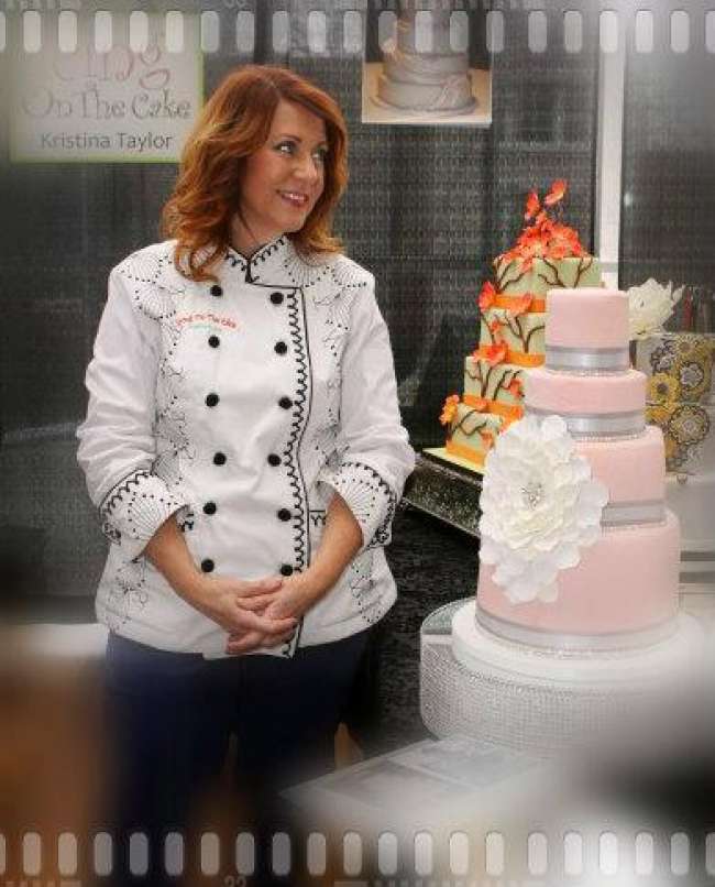 Baker standing next to her wedding cake masterpiece