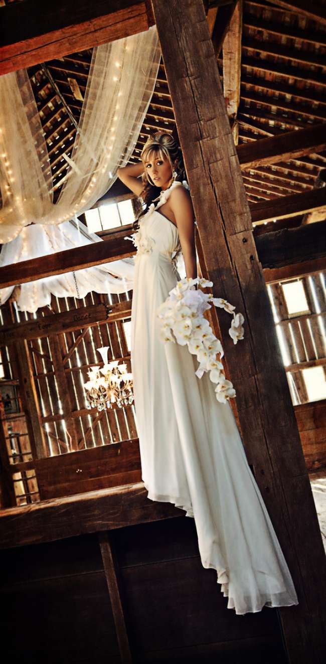 Bride Holding an Orchid Bouquet in Barn
