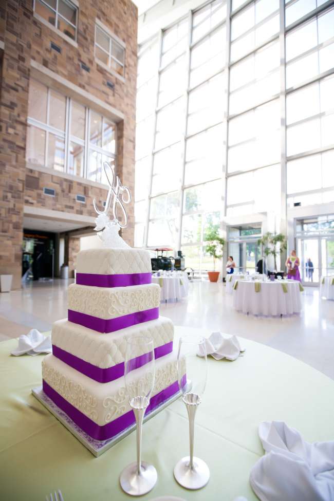 Four tiered wedding cake inside venue